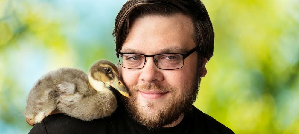 Employee of The Animal Foundation with duck